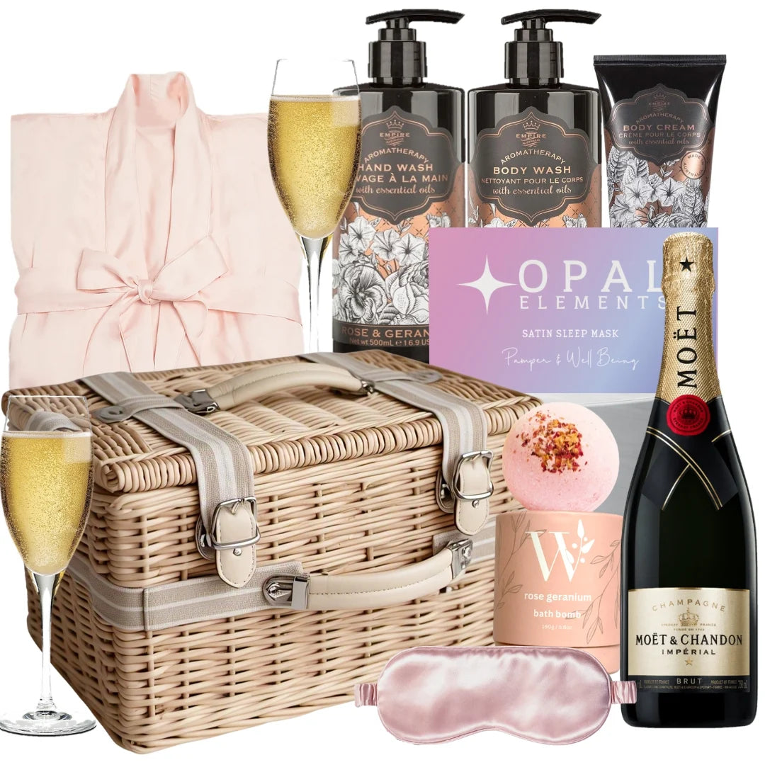 Luxury Moët Champagne spa gift hamper with rose and geranium body care products, a satin bathrobe, eye mask, and bath bomb