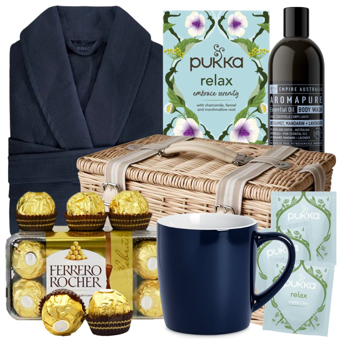 Get well gift basket for him featuring a blue waffle robe, herbal tea, mug, Ferrero Rocher chocolates, and body wash
