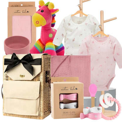 Collection of baby items including clothes, toys, and a basket on a white background.