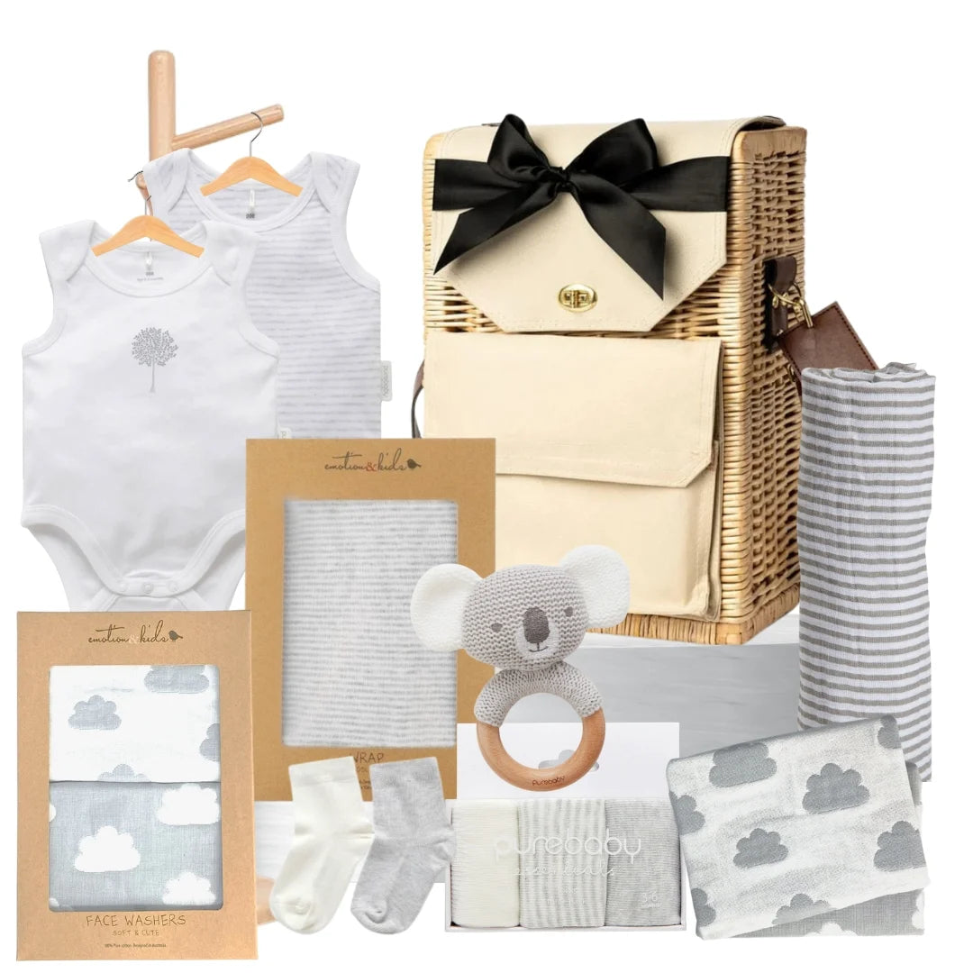 Baby gift basket with baby clothes, toys, and accessories on a white background