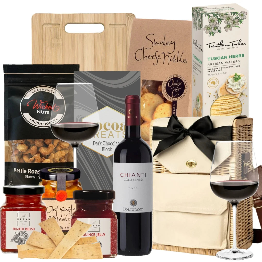 Gourmet gift basket with wine, snacks, and chocolate on a white background