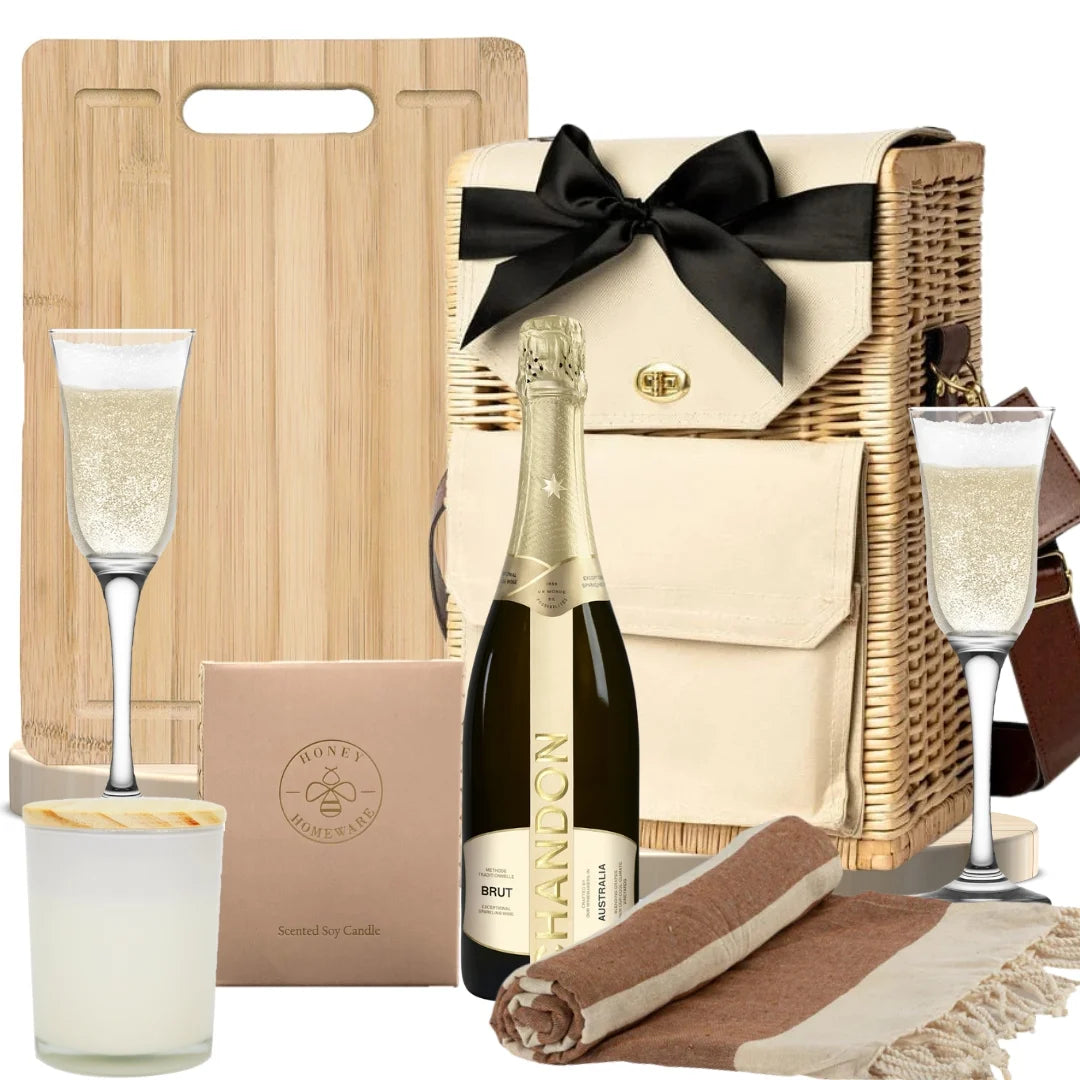 Chandon Brut sparkling gift hamper featuring champagne, champagne flutes, a soy candle, and a Turkish beach towel
