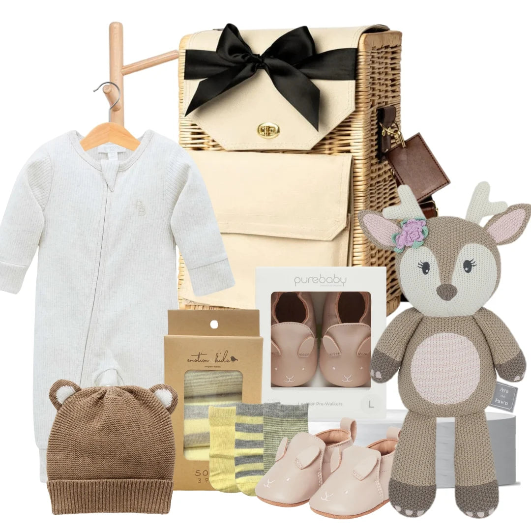 Baby essentials gift hamper featuring a knitted fawn toy, Pure Baby growsuit, bunny shoes, beanie, and socks