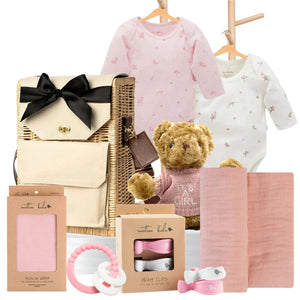 Baby girl gift hamper featuring Pure Baby bodysuits, a teddy bear, muslin wrap, pram clips, and a pink teether