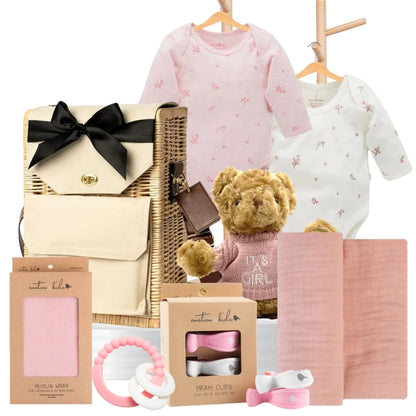 Baby girl gift hamper featuring Pure Baby bodysuits, a teddy bear, muslin wrap, pram clips, and a pink teether