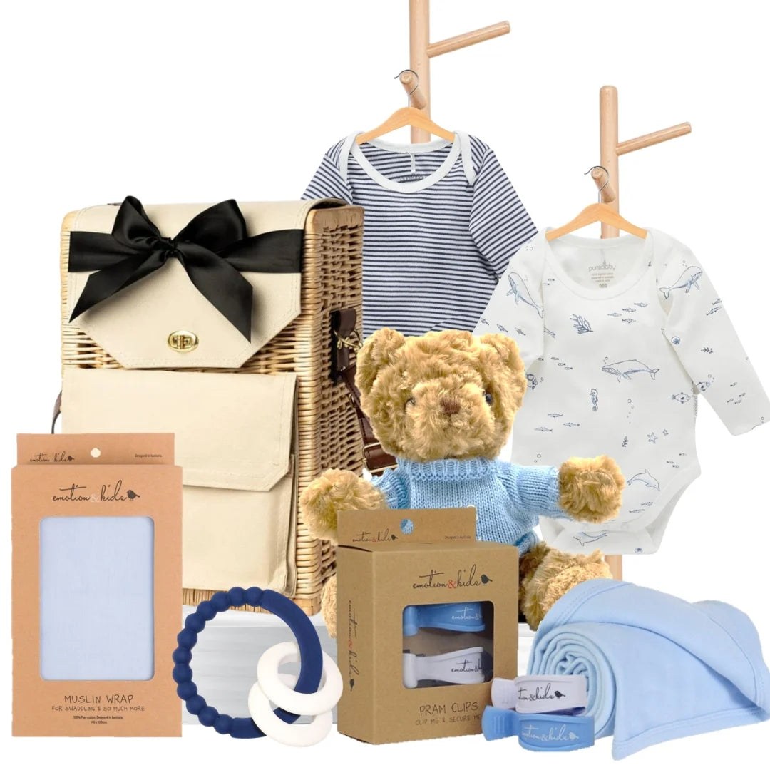 Baby boy gift hamper featuring Pure Baby bodysuits, a teddy bear, muslin wrap, pram clips, and a blue teether