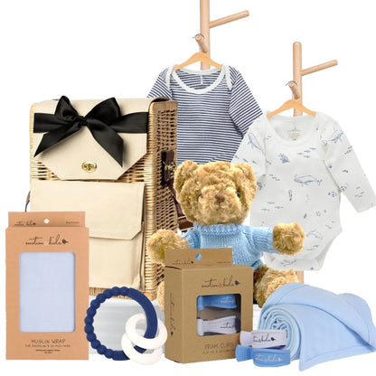 Baby boy gift hamper featuring Pure Baby bodysuits, a teddy bear, muslin wrap, pram clips, and a blue teether